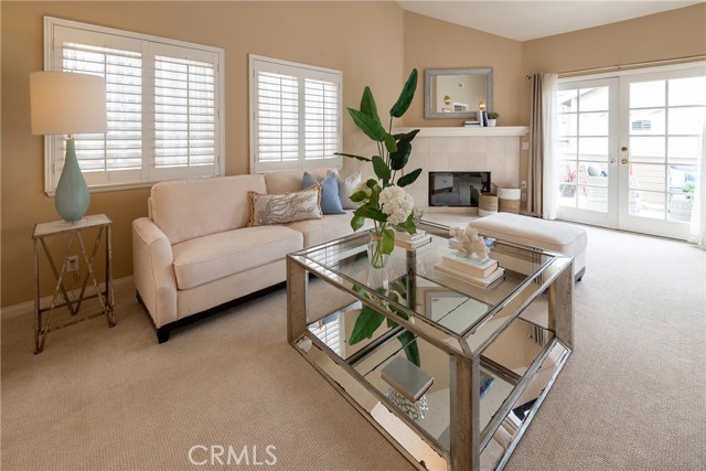 Sunny and bright living room. Fireplace. Patio doors open to large deck.