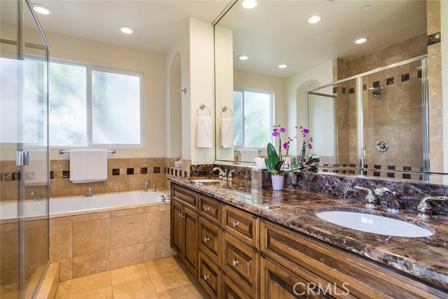 Master bath includes a jetted spa tub, linen closet, dual sinks, walk-in shower and private water closet.