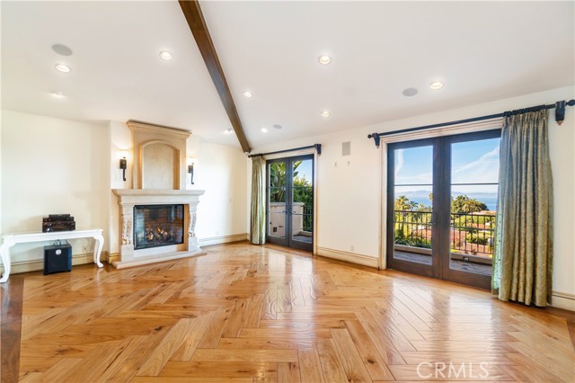 Family Room with grand fireplace and access to large balcony.