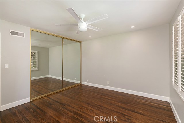 Guest Bedroom on front of house with huge closet with loads of storage, high efficiency remote controlled ceiling fan, and recessed LED lighting.