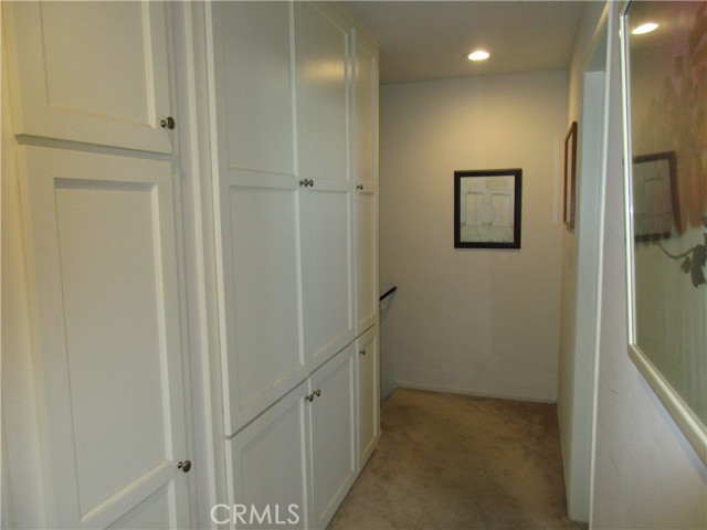 Unit #1 Hallway upstairs with  storage space.