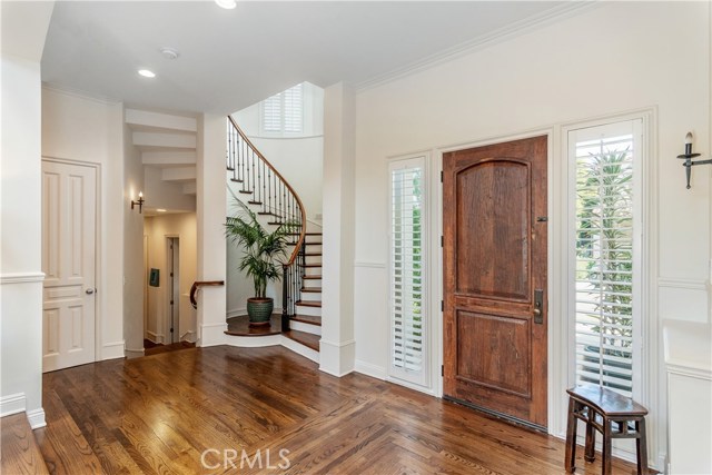 Landing at entry with a view of the dramatic curving staircase.