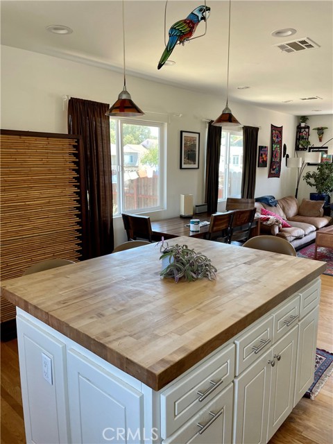 View from the kitchen island/ breakfast bar towards the dining and living areas.
