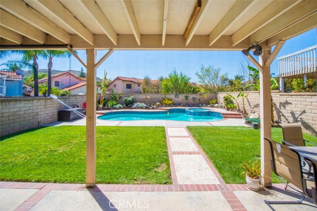 Sliding glass doors leading to the sparkling pool and Jacuzzi.