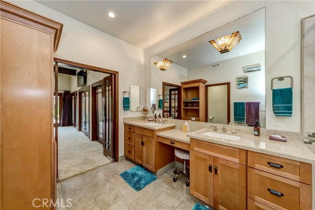 Master Bathroom , double sink , Linen Closet, toilet with door.