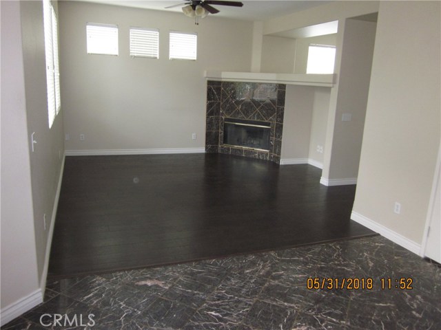 Cozy family room adjacent to kitchen, please note tile in kitchen and new wood flooring in family room.