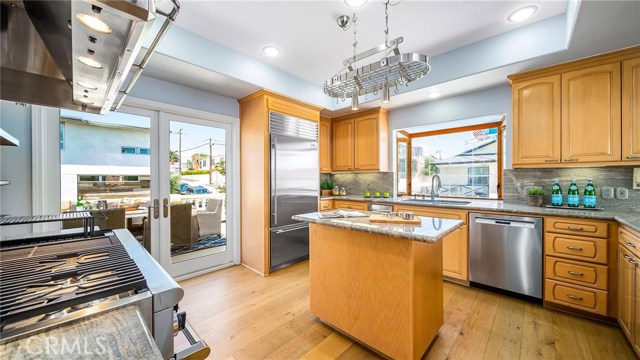 Gourmet kitchen with marble counters and stainless fixtures with Bosch dishwasher and a Kitchen Aid trash compactor.  Deck off  kitchen to the left.