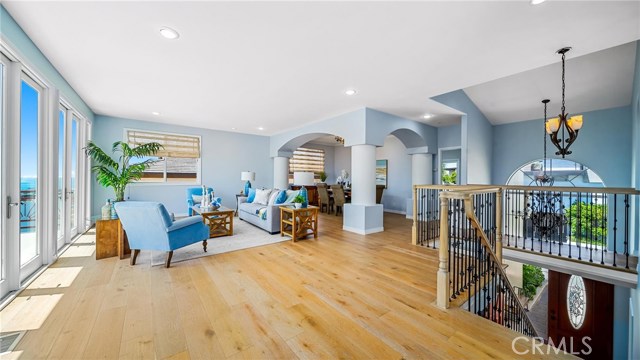 Living room and dining room at the landing at the top of the steps.  Upstairs bedroom can be seen to the right of the dining room.