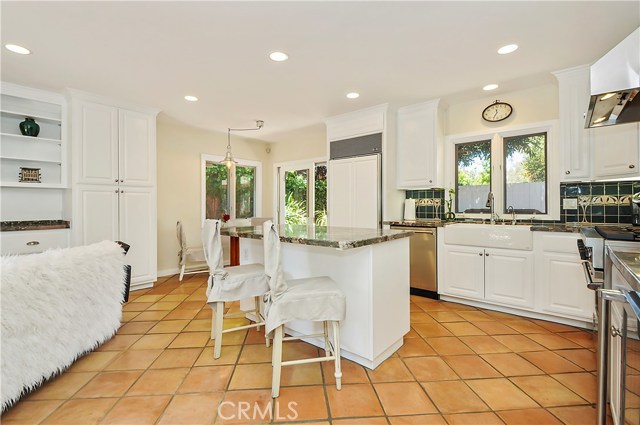 Gorgeous tile flooring throughout adds a wonderful contrast to the kitchen.