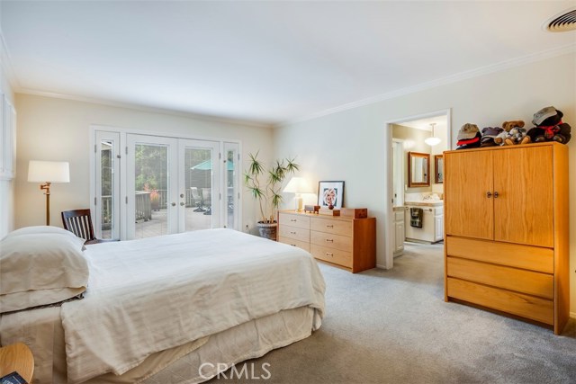 Expansive Master suite with French doors leading out to the side deck