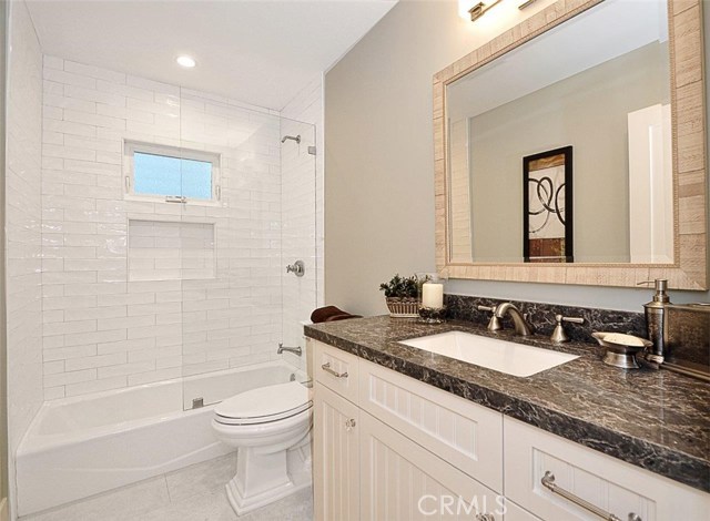 Hallway bathroom with custom built cabinet and Cesarstone countertop