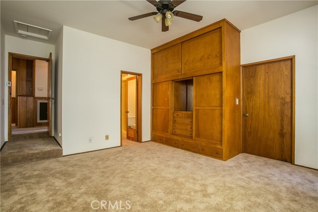 The sunken master bedroom off of the main entry foyer is very spacious with an ample storage closet area and a full bath.