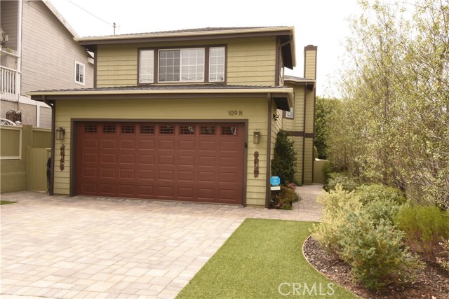 Beautiful exterior with paver stone driveway and pretty landscaping.  Walkway leads to private entrance!