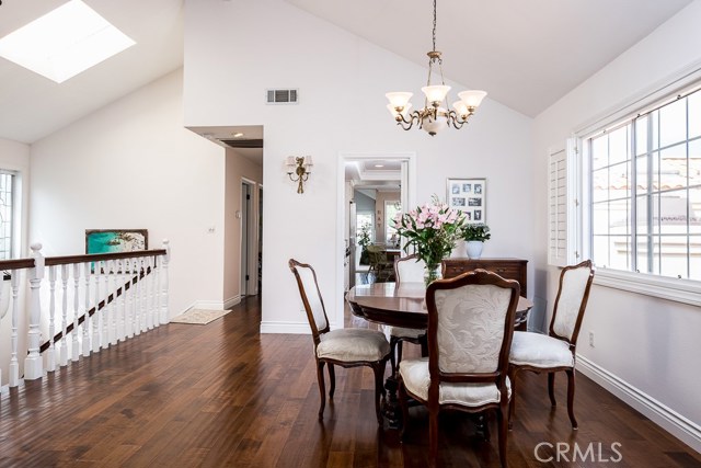 Dining room with vaulted ceiling and skylights