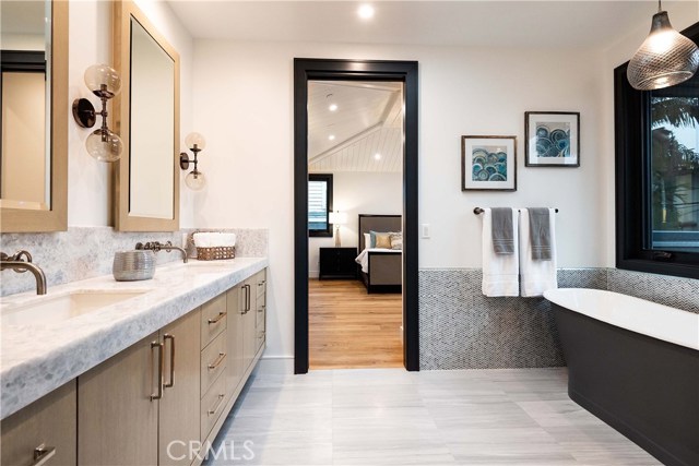 Master Bath with Custom Tile throughout with Glass Tile Accent. Stand Alone, High Quality Bathtub. 5.5’ x 3.5’ Enclosed Custom Tiled Shower with Steam, High Quality Kohler Shower Fixtures and Floating Bench.