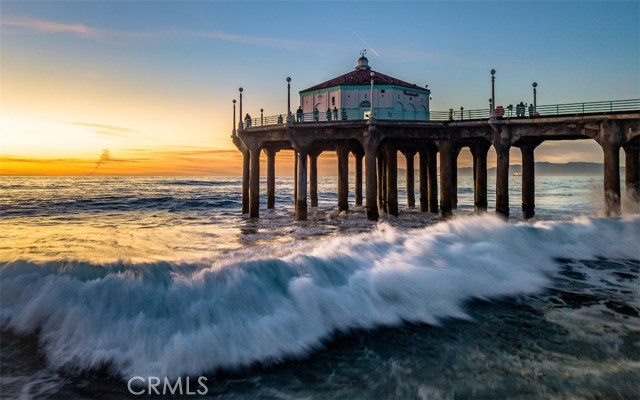 Waves crashing on the shores of Manhattan Beach on South side of pier.