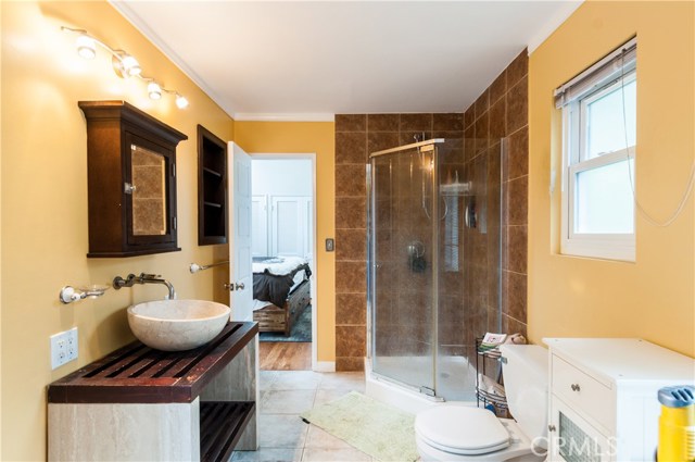 Master bathroom has tiled floors, corner shower and good lighting.