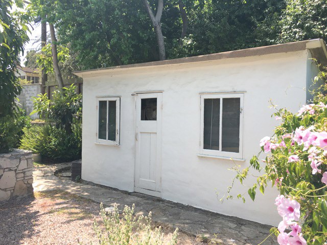 Utility shed behind garage