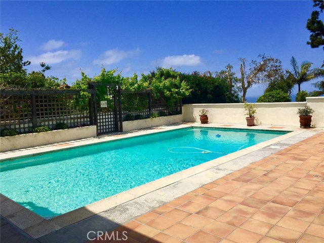 Serene rear yard with pool.