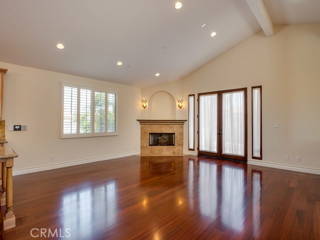 Bright and spacious living room has beautiful fireplace and french doors to large balcony.