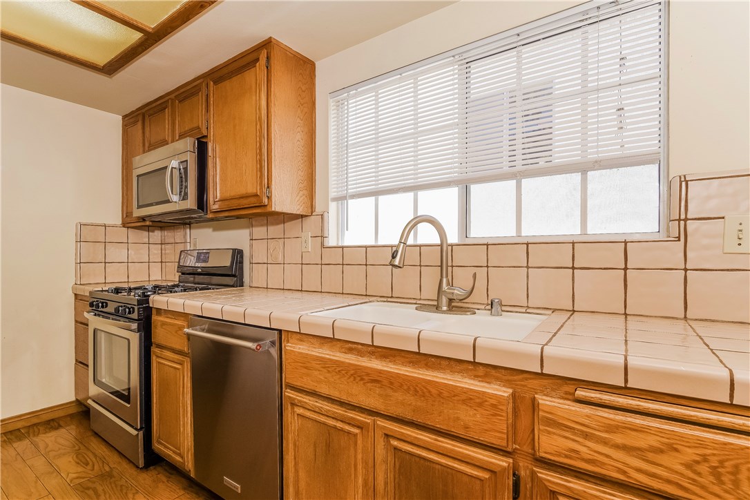 The kitchen features newer stainless steel appliances