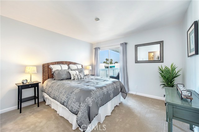 Beautiful and bright bedroom with access to the balcony and deck, huge walk in closet, new carpet, new paint, baseboards and smooth coat ceiling