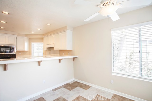 Breakfast bar and nook with ceiling fan