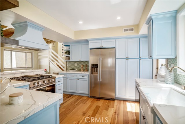 From your living room you can see why the cook may not want to leave the kitchen. The pantry doors have new storage and the cabinetry is solid and spacious. Self closing drawers too. What's for dinner!