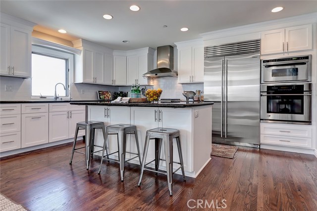 Updated kitchen with granite countertops, stainless steel appliances and SubZero refrigerator. 
