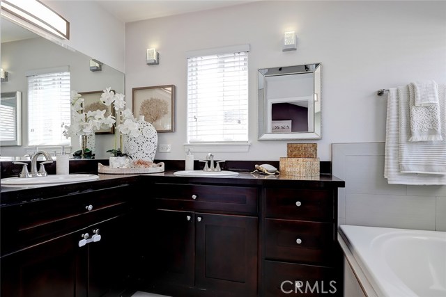 Remodeled master bathroom with dual sink granite countertops, soaking tub and separate walk-in shower.