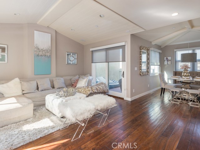 Open floor plan living room, dining and outside patio high ceilings and striking design elements