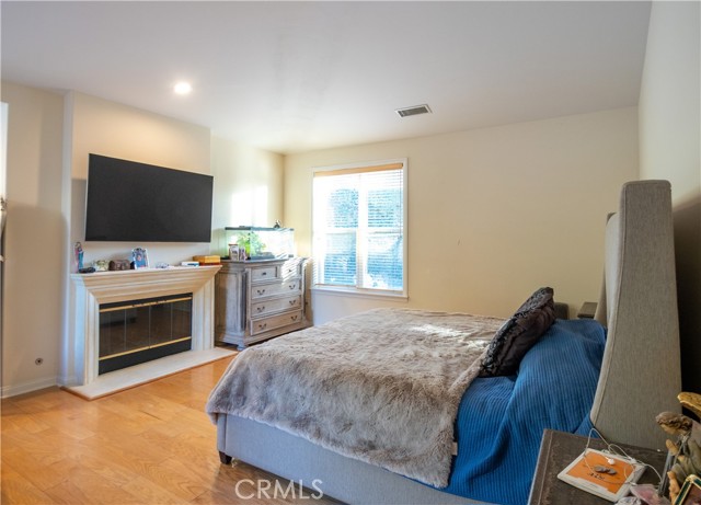 Owners bedroom with a fireplace and walk in bathroom
