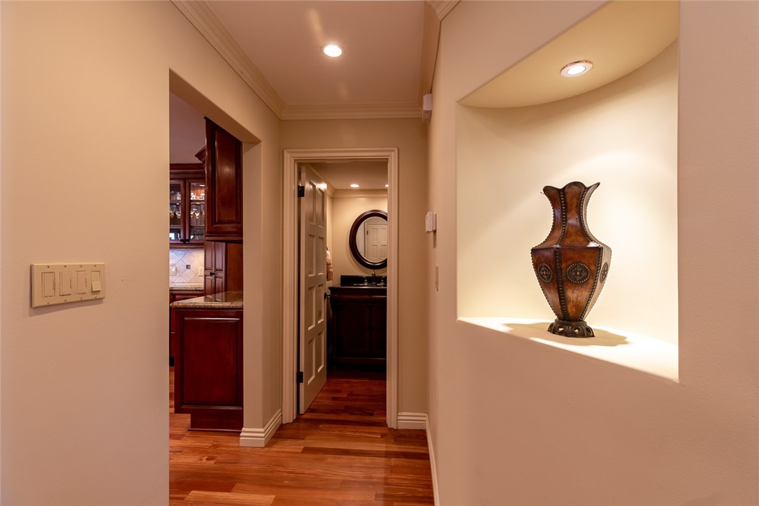 Entrance to kitchen from front hallway.  Powder room in background