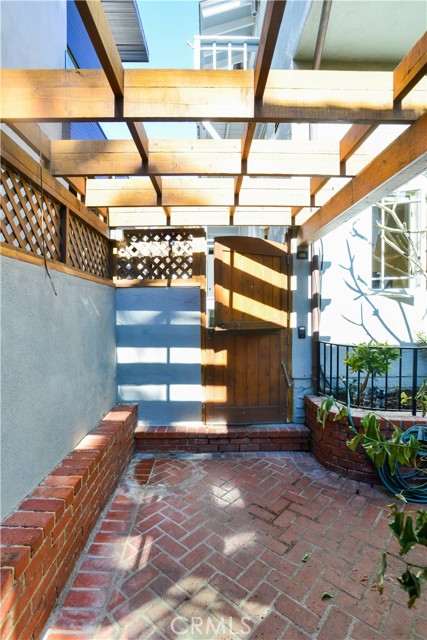 Rear entry gate leading to garage. This leads you to Palm Drive as well as this is a street to alley lot. This area of Palm Drive is one of the wider alleys in Hermosa Beach.