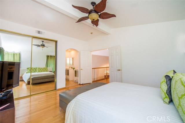 Large master bedroom with a balcony overlooking the pool.