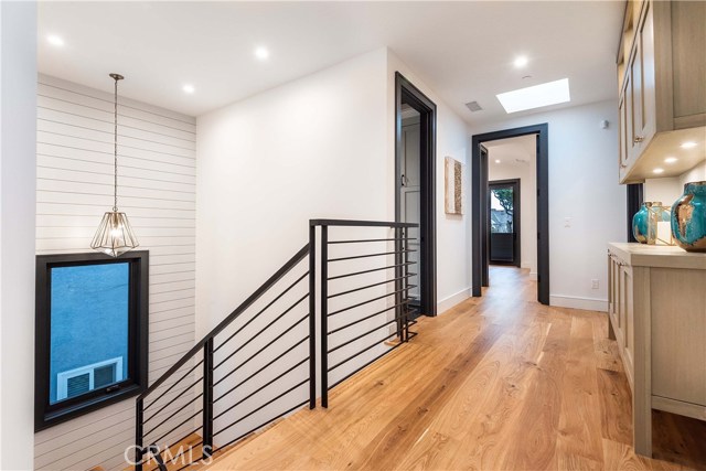 The wide upstairs hallway leads to the four upstairs bedrooms. Two skylights ensure natural light. Convenient laundry room located at the head of the stairway.