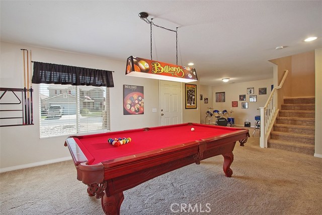 Living room showing music room beyond.  Smooth ceilings, newer paint and carpet.  I've heard that family's who play together, stay together.