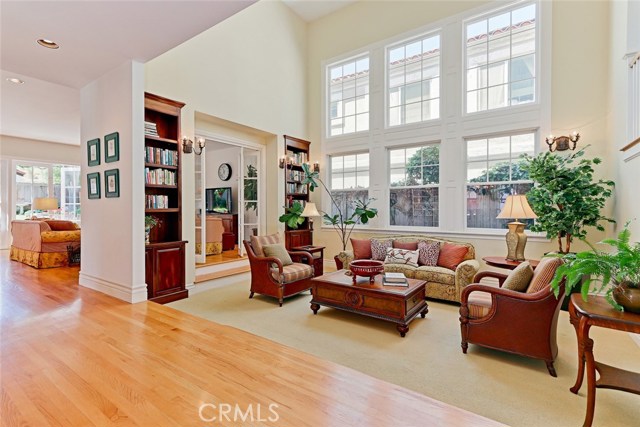 Formal living room with 2 story ceiling and windows.