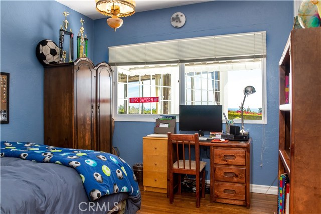 Boys bedroom on the ocean side with a good view and hardwood floors.