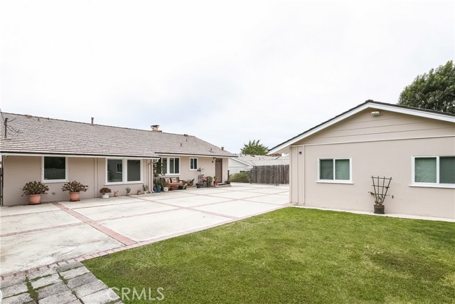 View of rear of home, garage, studio and driveway