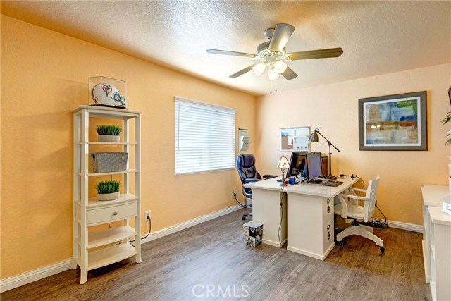 Additional spacious upstairs bedroom #2, currently being used as an office.  Ceiling fans throughout all bedrooms.