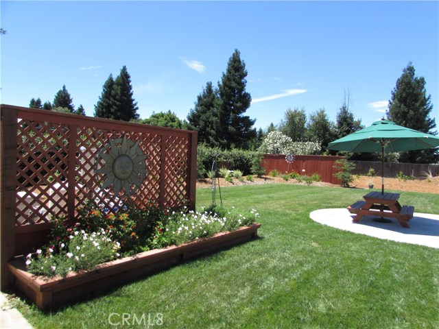 Flower bed and decorative fence to cover up pool equipment.