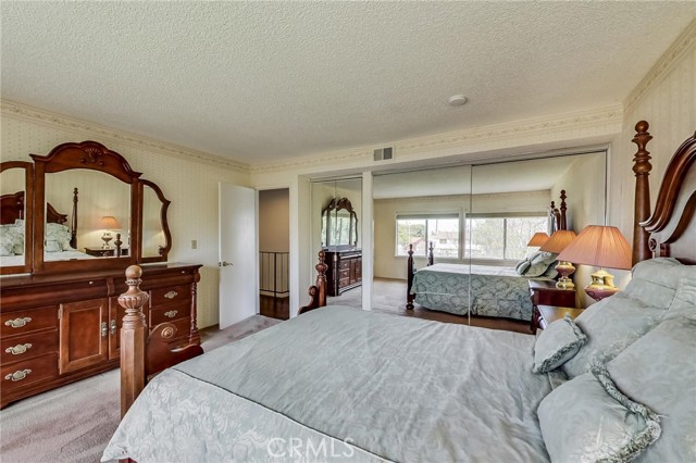 Main bedroom with mirrored wardrobe doors.