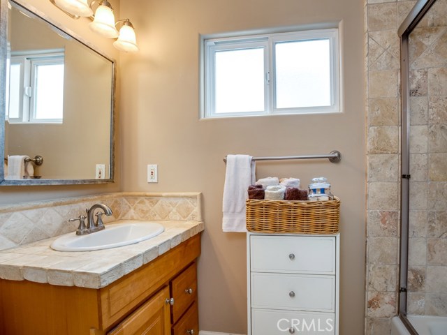 Beautiful bath with travertine shower and counter top.