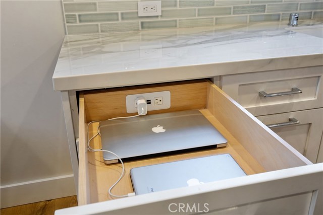 Built-in electronics docking station in the cabinetry - a must-have for sure.