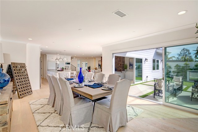 Dining room area with enough room to seat 12-15 comfortably, dual retractable doors to backyard for wonderful open living.