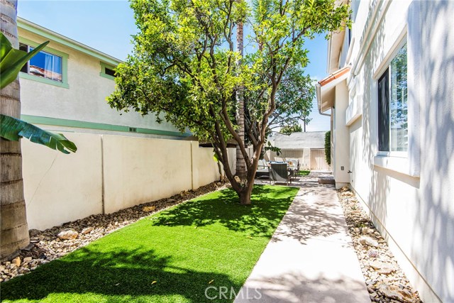 Spacious backyard recently landscaped with turf for low maintenance upkeep.