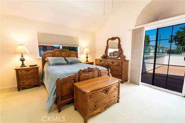 Master bedroom with high vaulted ceilings and custom black out shades and blinds