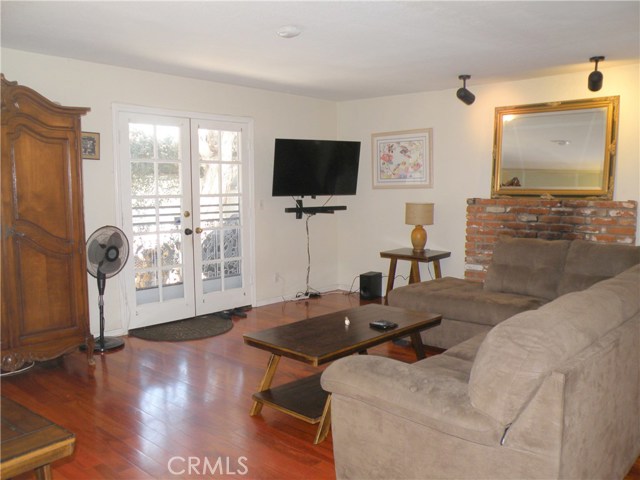 Family room with cherrywood floors and French doors to rear patio