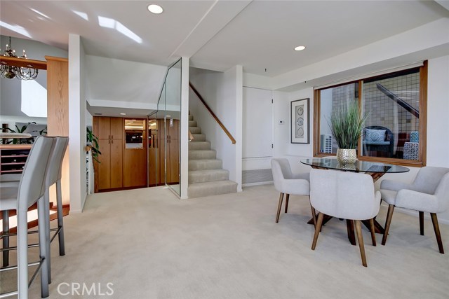 Family Room, Bar and View Deck to the left. Kitchen is down the stairs (left) and the stairs going up to the right goes up to bedrooms.